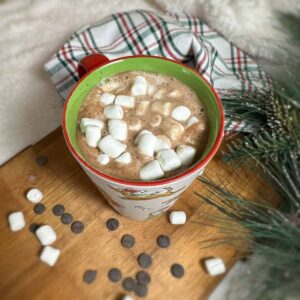 Cup of hot chocolate topped with marshmallows.